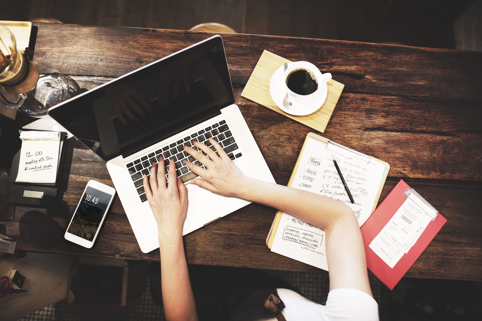 Preparing a visa application at a desk with laptop and notes