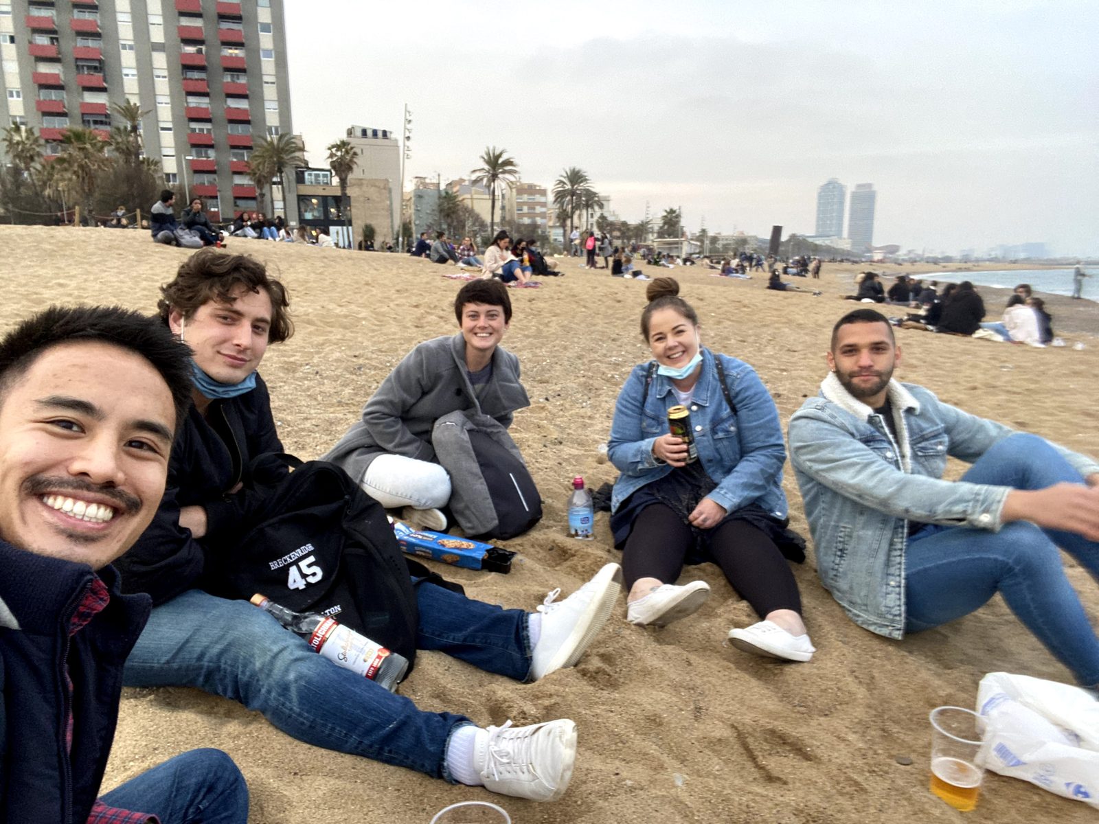 Students relaxing on the beach in Barcelona