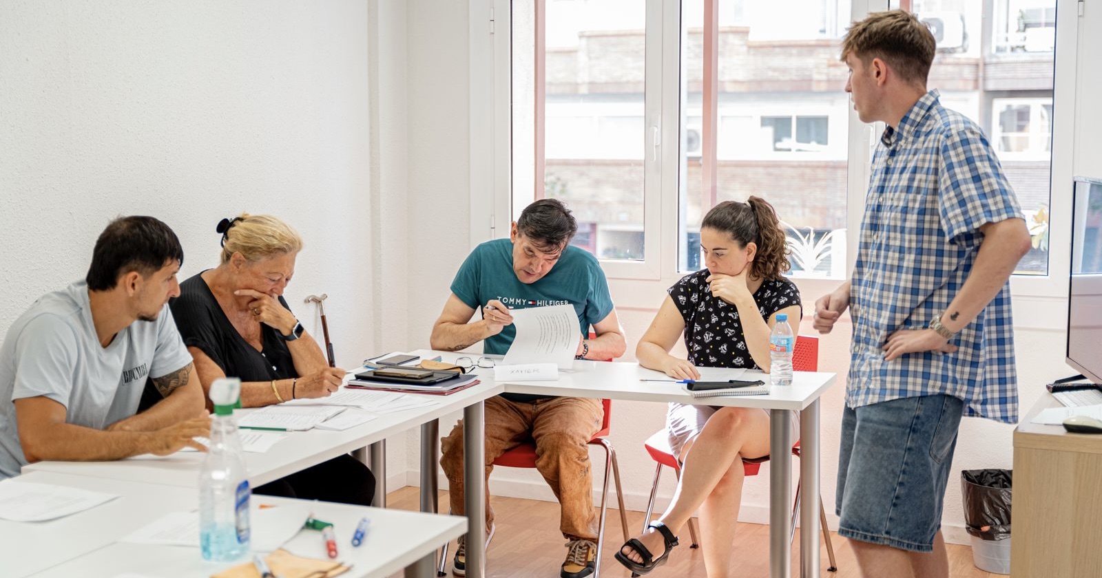 International student working part-time in a Barcelona café while studying Spanish on a student visa.