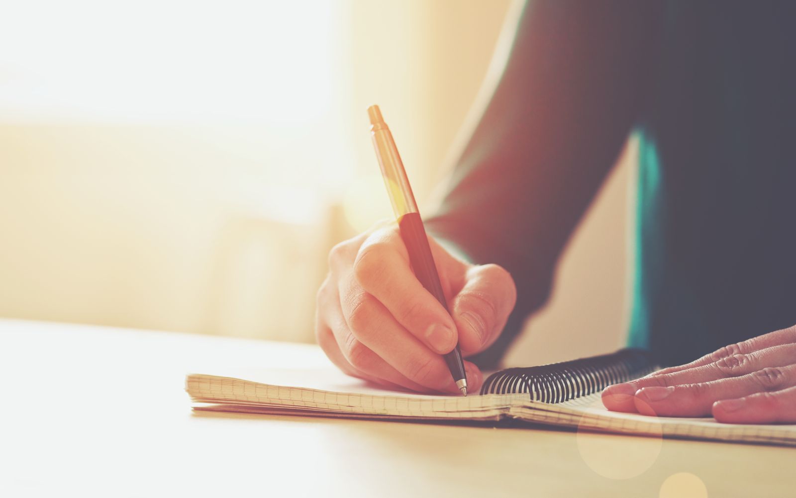 A cover letter and Spain student visa documents laid out on a desk with a pen.